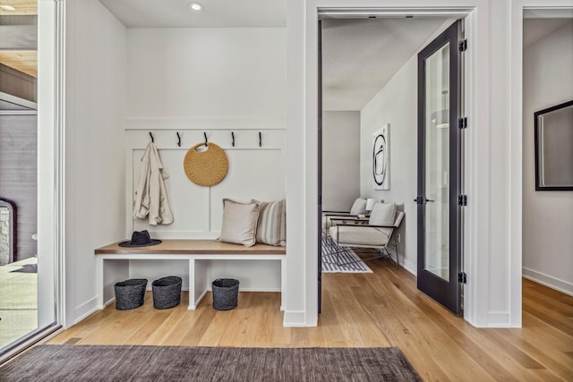 mudroom with wood-type flooring