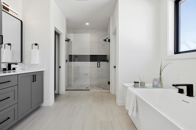 bathroom with vanity and separate shower and tub