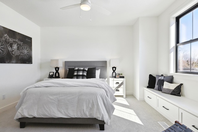 bedroom with ceiling fan and light colored carpet