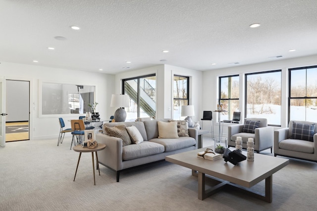 carpeted living room featuring a textured ceiling