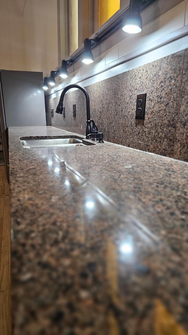 interior details featuring backsplash and sink