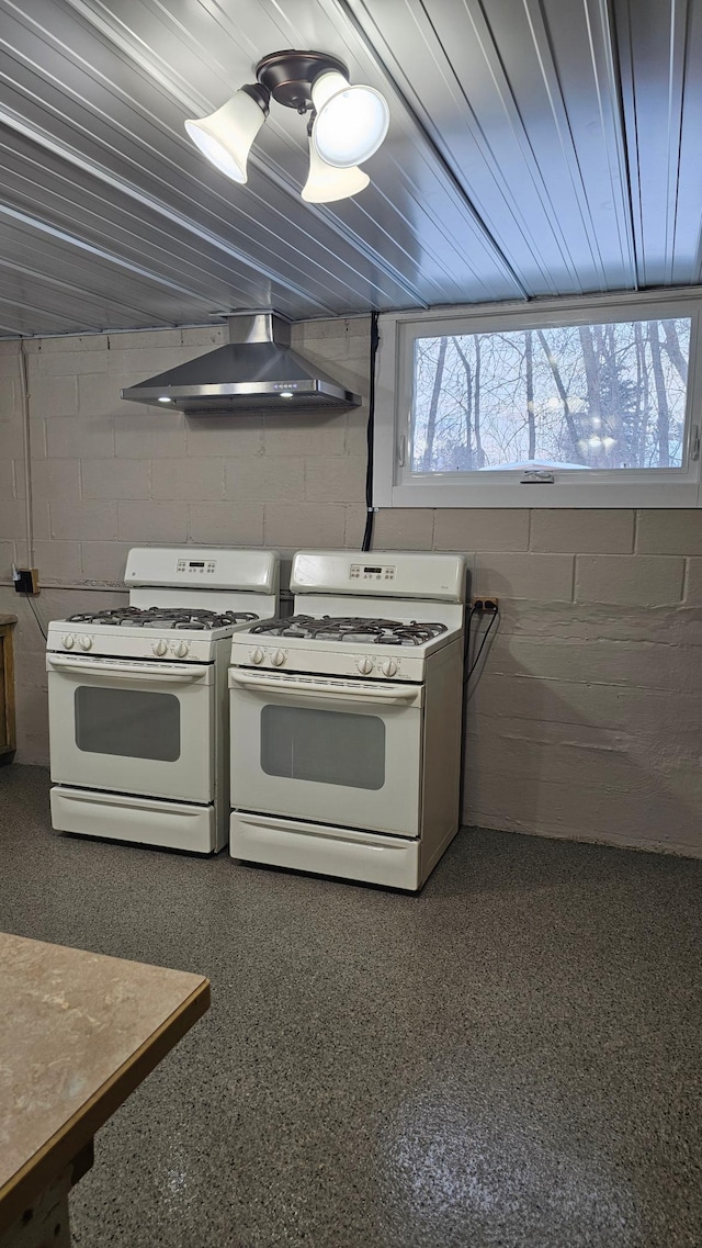 kitchen featuring white gas stove and wall chimney exhaust hood