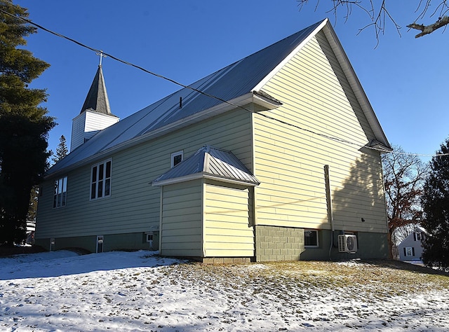 view of snowy exterior featuring ac unit