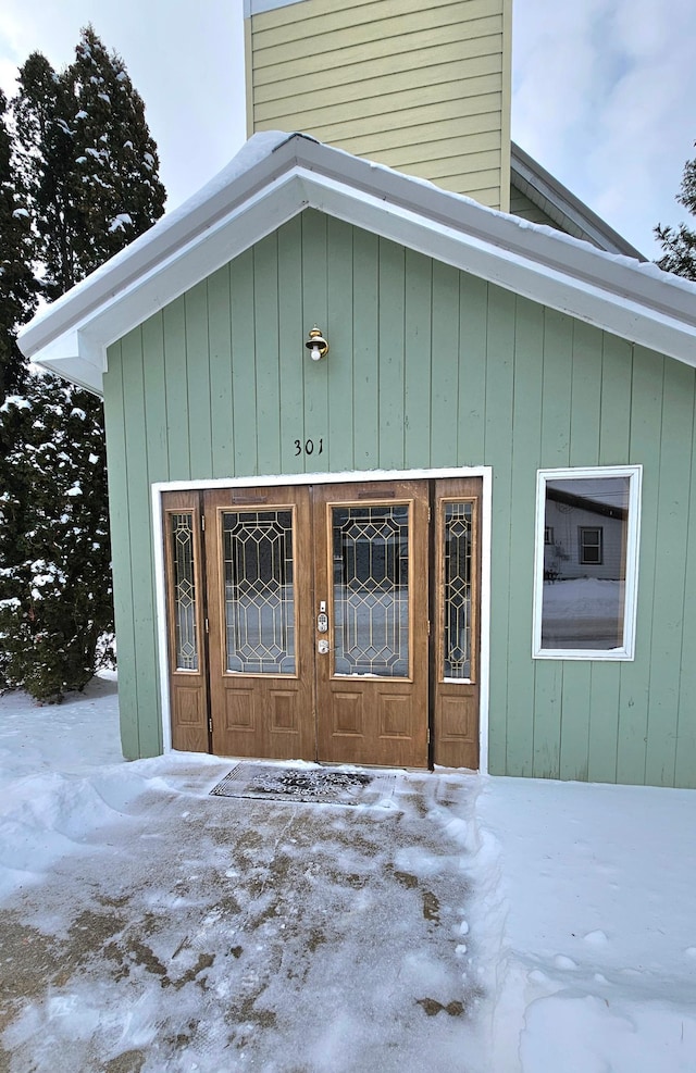 view of snow covered property entrance