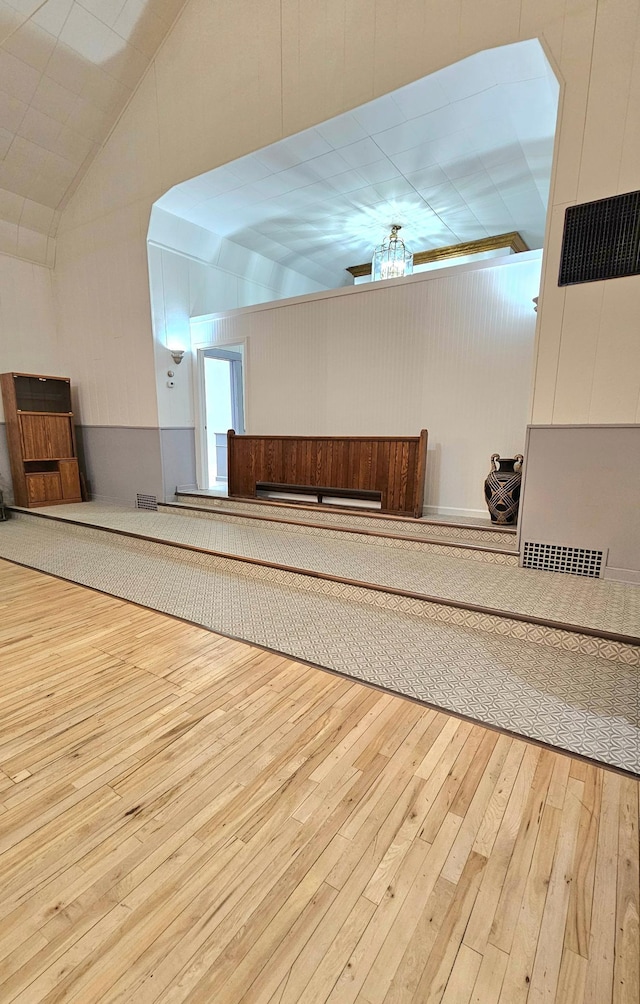 interior space featuring ceiling fan, vaulted ceiling, and hardwood / wood-style floors