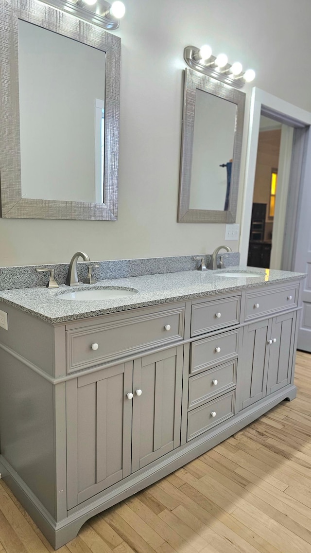 bathroom with hardwood / wood-style floors and vanity