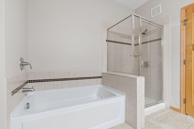 bathroom featuring shower with separate bathtub and tile patterned flooring