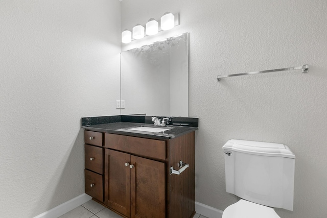 bathroom with vanity, tile patterned floors, and toilet