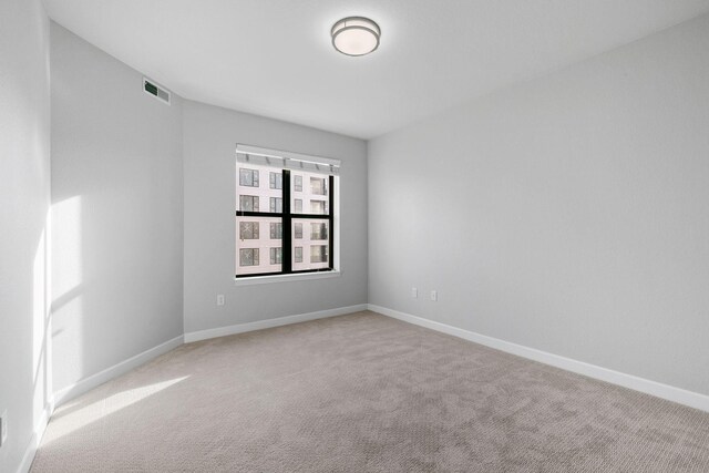 unfurnished room with light carpet