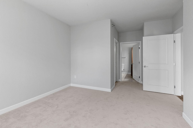 unfurnished bedroom with light colored carpet