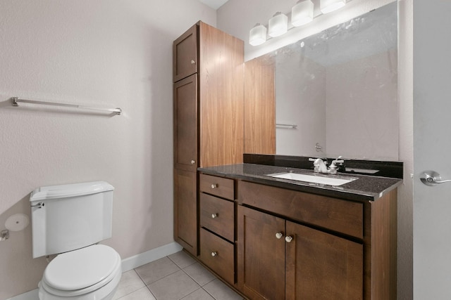 bathroom with tile patterned flooring, vanity, and toilet