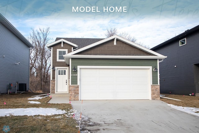 craftsman-style home featuring central AC and a garage