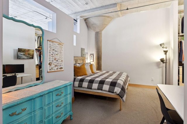 carpeted bedroom with a towering ceiling