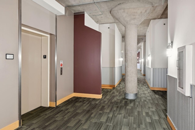 corridor featuring elevator and decorative columns