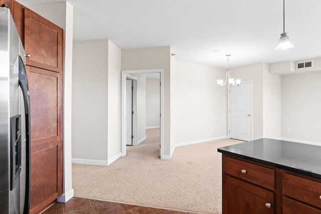 kitchen featuring decorative light fixtures, a notable chandelier, dark carpet, and stainless steel fridge with ice dispenser