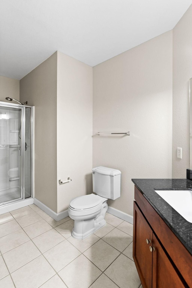 bathroom with walk in shower, vanity, toilet, and tile patterned flooring