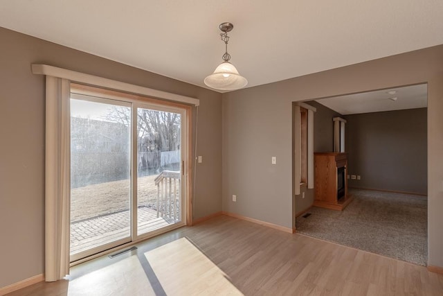 1733 Bassett Dr, Mankato, MN 56001 - spare room featuring a fireplace, visible vents, light wood-type flooring, and baseboards