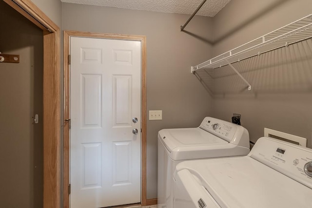 1733 Bassett Dr, Mankato, MN 56001 - clothes washing area with washing machine and dryer, laundry area, and a textured ceiling
