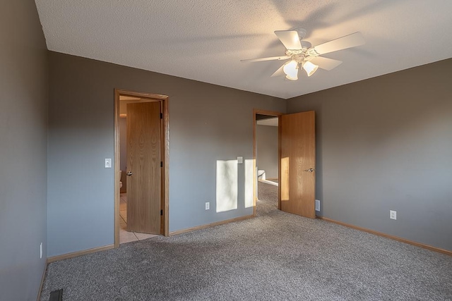 1733 Bassett Dr, Mankato, MN 56001 - unfurnished bedroom with visible vents, baseboards, ceiling fan, a textured ceiling, and light carpet