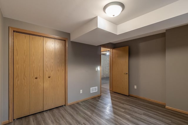 1733 Bassett Dr, Mankato, MN 56001 - unfurnished bedroom with wood finished floors, baseboards, a closet, and visible vents