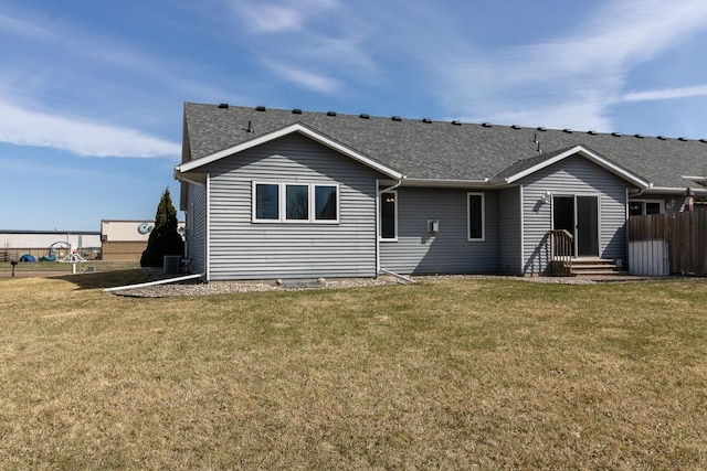 1733 Bassett Dr, Mankato, MN 56001 - rear view of property featuring roof with shingles and a lawn
