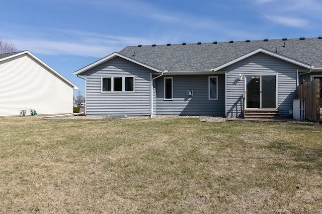 1733 Bassett Dr, Mankato, MN 56001 - back of house with entry steps, a shingled roof, and a lawn