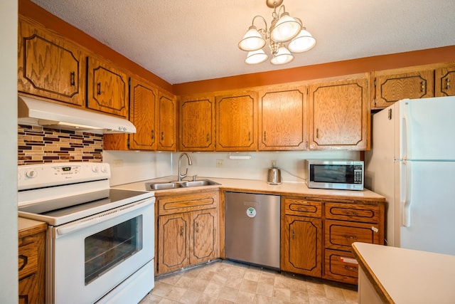 14962 Dodd Blvd, Rosemount, MN 55068 - kitchen featuring stainless steel appliances, under cabinet range hood, a sink, brown cabinetry, and a textured ceiling
