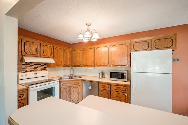 14962 Dodd Blvd, Rosemount, MN 55068 - kitchen featuring stainless steel appliances, under cabinet range hood, a sink, and light countertops