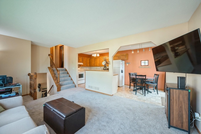 14962 Dodd Blvd, Rosemount, MN 55068 - living room featuring a chandelier, light carpet, and stairway