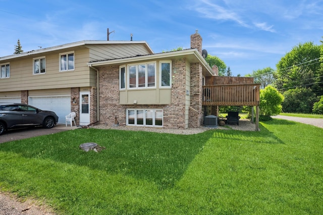 14962 Dodd Blvd, Rosemount, MN 55068 - back of house with a chimney, brick siding, a lawn, and central air condition unit