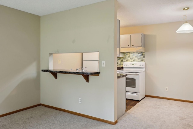 kitchen with decorative backsplash, dark carpet, white appliances, pendant lighting, and cream cabinetry