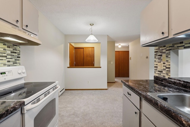 kitchen with backsplash, white range with electric cooktop, white cabinets, and a baseboard radiator