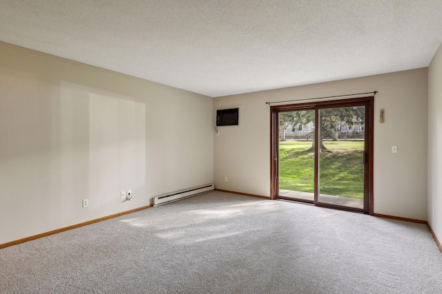 spare room featuring carpet flooring, a wall mounted air conditioner, a baseboard radiator, and a textured ceiling