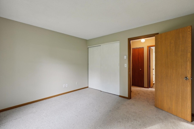 unfurnished bedroom with a closet and carpet floors