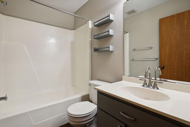 full bathroom with shower / tub combination, vanity, and toilet