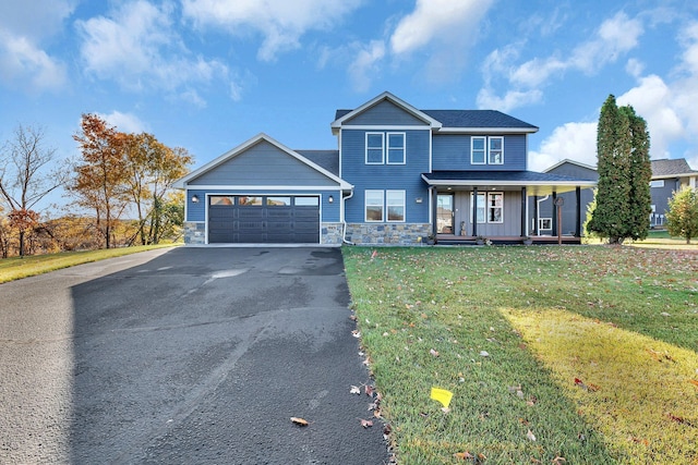 view of front of property featuring a porch, a garage, and a front lawn