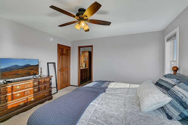 carpeted bedroom with connected bathroom and ceiling fan