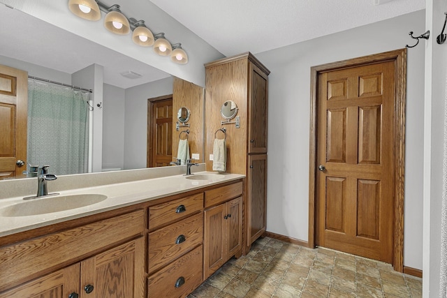 bathroom featuring vanity and curtained shower