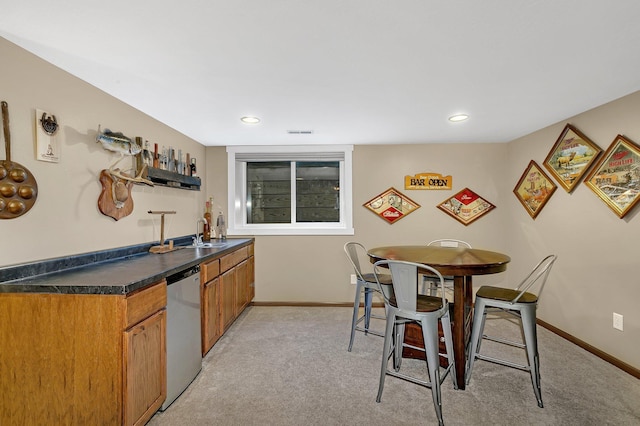 kitchen featuring light carpet, sink, and stainless steel dishwasher