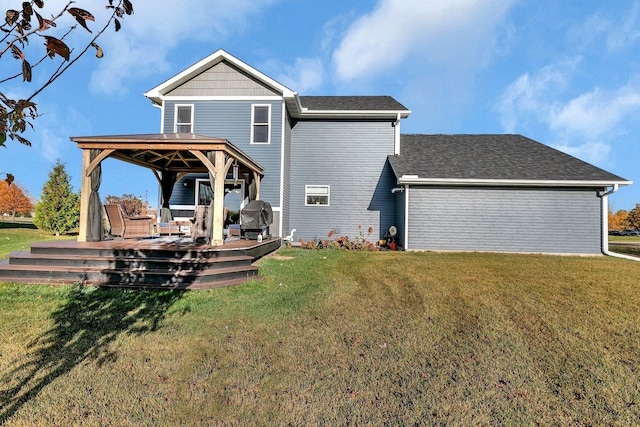 back of house with a gazebo, a deck, and a lawn