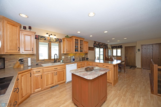 kitchen with sink, a center island, black electric cooktop, dishwasher, and kitchen peninsula