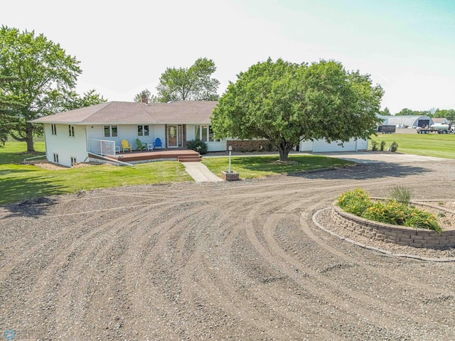 view of front of house with a garage and a front lawn