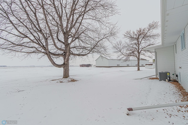 yard covered in snow featuring central AC