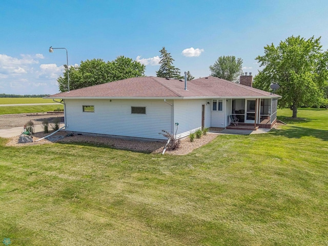 back of property with a yard and a sunroom