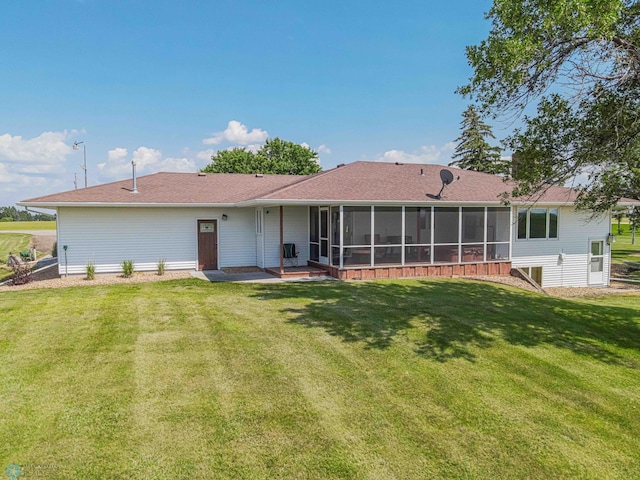 back of house featuring a yard and a sunroom