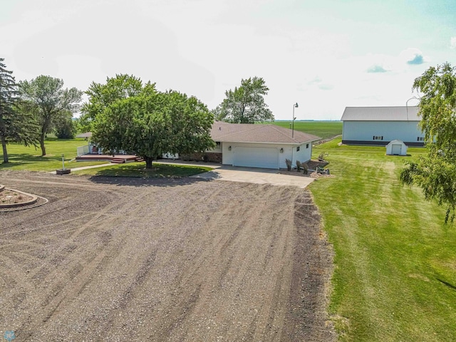 view of front of house with a garage and a front lawn