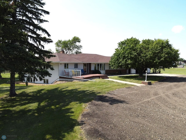 single story home featuring a front lawn