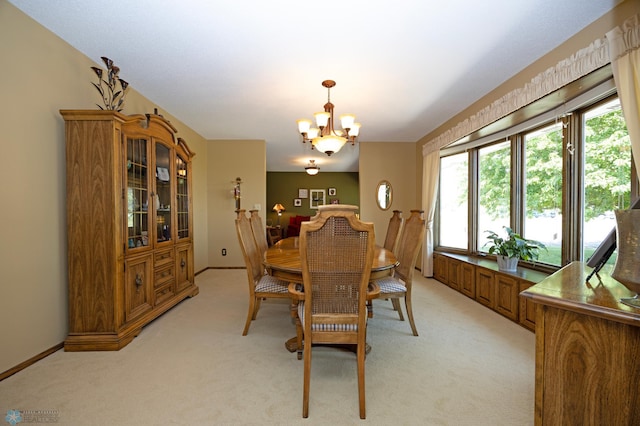 dining area featuring light carpet and an inviting chandelier