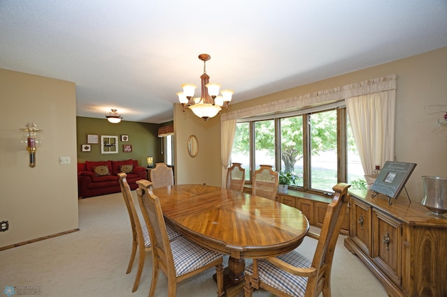 carpeted dining area featuring a notable chandelier