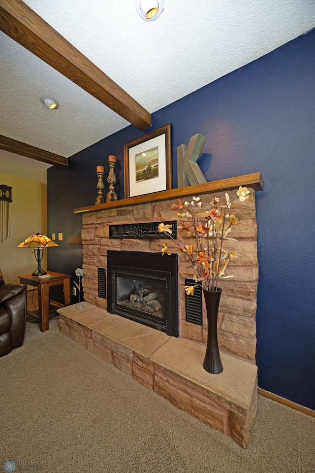 carpeted living room with beam ceiling, a fireplace, and a textured ceiling